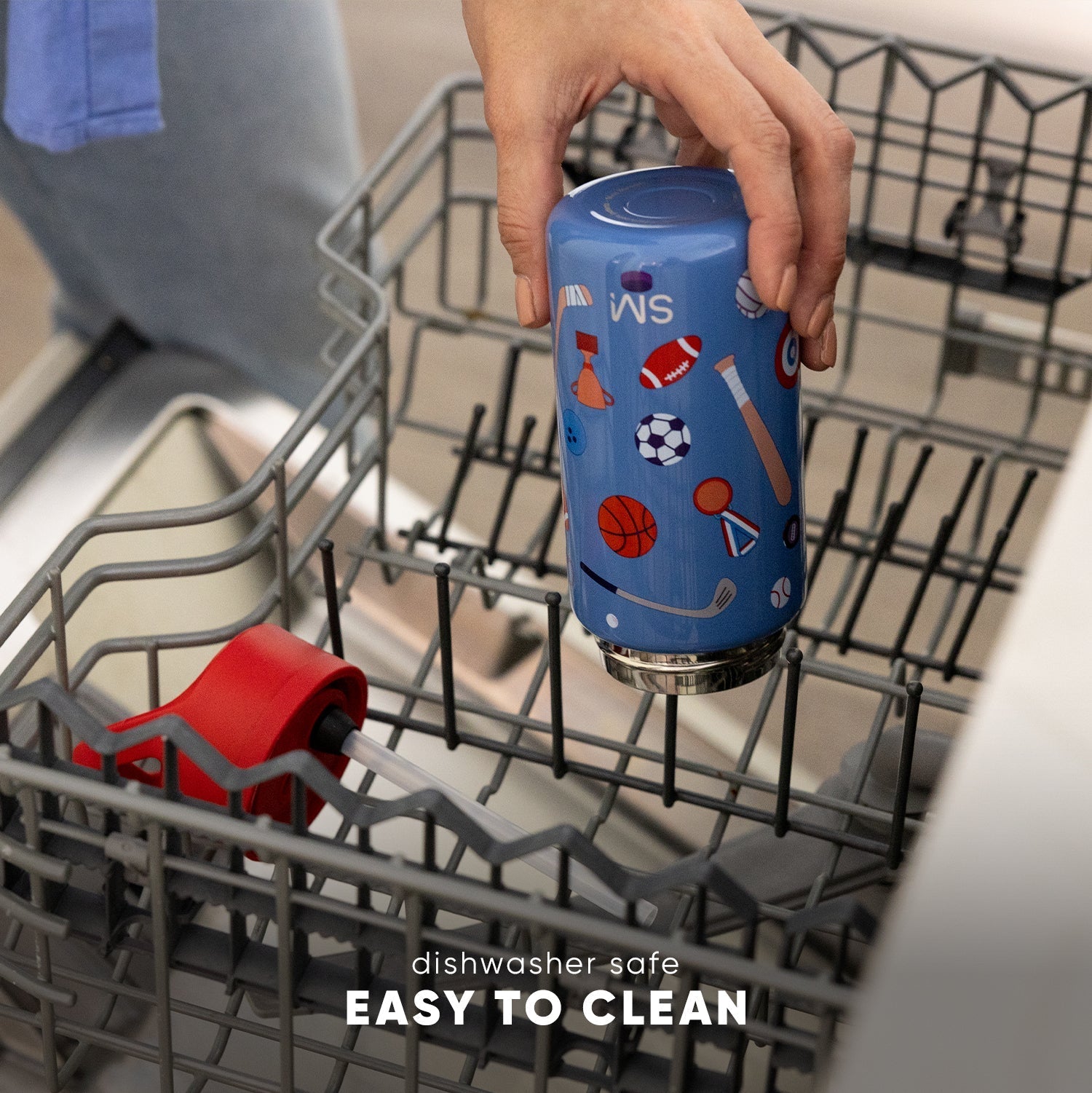 Blue insulated drinkware with sports graphics held in a hand inside an open dishwasher with wire racks. Text reads "dishwasher safe" and "EASY TO CLEAN."